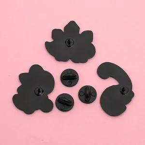 Back view of cute cartoon dinosaur enamel pins with three black rubber clutch backings