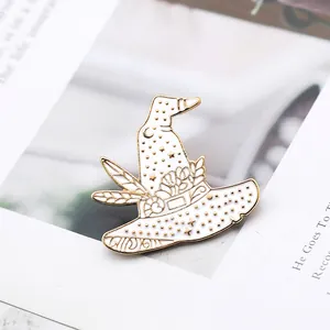 Macro detail of wizard hat enamel pin with gold crescent moon and star patterns