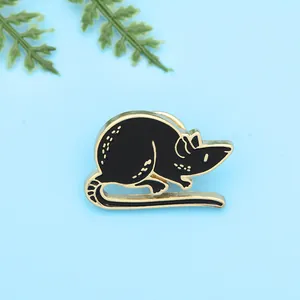 Detail of cute black enamel cartoon mouse brooch with elegant gold metal outlines