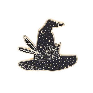 Detailed close-up of a black enamel magic hat brooch with gold trim and moon stars
