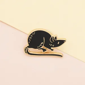 Close-up of black enamel mouse brooch with gold edges and secure butterfly metal clasp