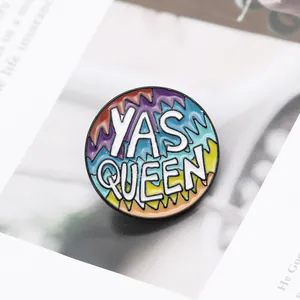Detailed close-up of rainbow enamel Yas Queen brooch with colorful wave pattern