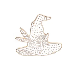 Detailed macro view of white enamel wizard hat brooch with gold moon and star accents