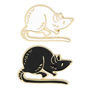 Detailed view of black and white cartoon mouse enamel pins with gold metal borders