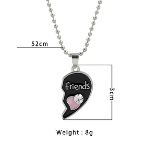 Half heart best friends necklace with black enamel friends lettering and pink heart charm