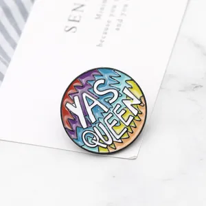 Rainbow enamel pin with Yas Queen text on marble background for stylish fashion