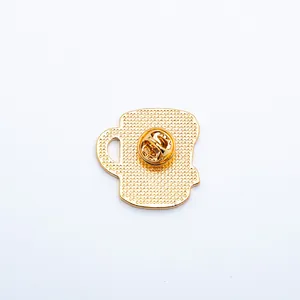 Detailed back view of a golden tea cup pin featuring a textured finish and butterfly clasp