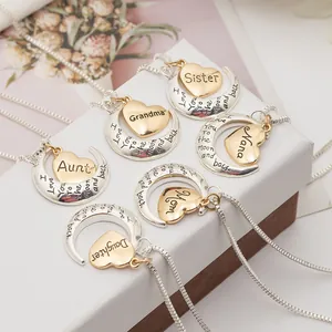 Detail of moon and heart pendant necklaces with engraved family member names for gift