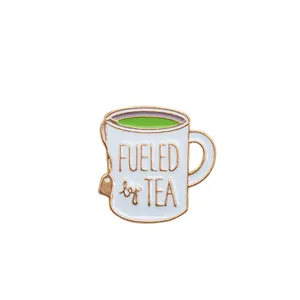 Cartoon enamel tea cup pin with Fueled by Tea slogan and rose gold metal edging