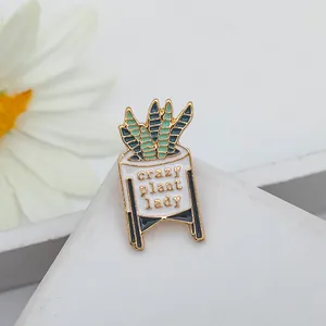 Detail of enamel pin with Sansevieria plant in a white pot saying Crazy Plant Lady