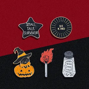 Set of 5 enamel pins featuring Halloween pumpkin, matchstick, and inspirational slogans