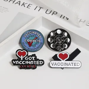 Detailed macro of enamel vaccinated lapel pins and lunar phase badges in a display box