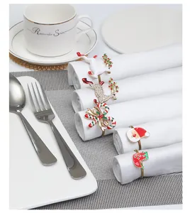 Close-up of assorted Christmas napkin rings with reindeer, Santa, and stocking motifs