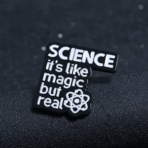 Macro detail of enamel science badge featuring quote and atomic structure icon