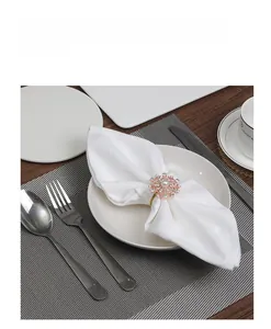 Detailed view of a gold snowflake napkin ring with faux pearls and sparkling crystals