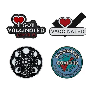 Set of four creative enamel pins featuring vaccine awareness and astronomical moon phase themes