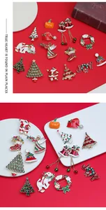Close-up of festive enamel Christmas brooches featuring Santa, trees and JOY lettering