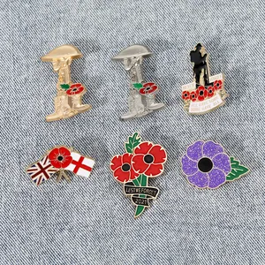 Detailed close-up of six commemorative enamel poppy brooches on a blue denim background