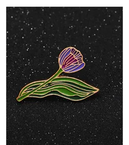 Detailed view of tulip enamel brooch with purple petals and golden metal edges
