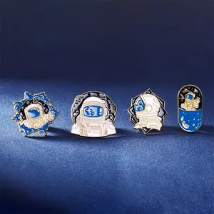 Starry sky astronaut enamel pin set featuring four unique deep blue and gold designs