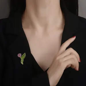 Elegant purple tulip alloy brooch pinned on a black suit lapel with gold edging