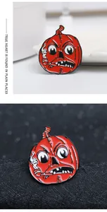 Macro detail of pumpkin monster enamel pin with vibrant orange finish and quirky pipe
