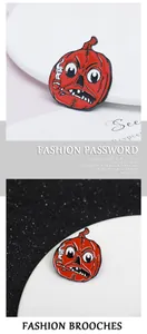 Detail of red enamel pumpkin brooch featuring a grumpy face and pipe on a black background