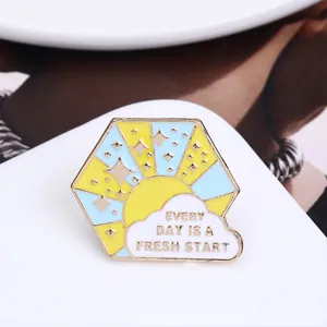 Hexagonal enamel sun and cloud brooch with Every Day Is A Fresh Start slogan
