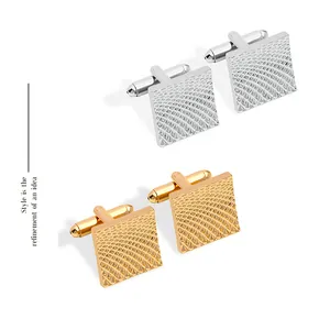 Detailed view of square cufflinks featuring geometric grid textures in gold and silver