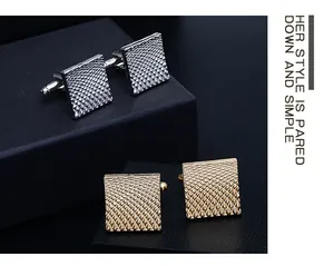 Close-up of square cufflinks with geometric pyramid texture in gold and silver finish