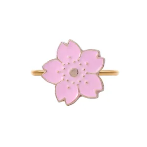 Detailed close-up of a pink sakura cherry blossom napkin ring with gold finish edges