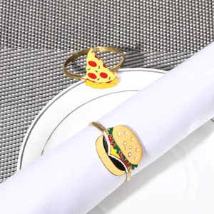 Detail view of colorful pizza and burger napkin rings with golden enamel finish