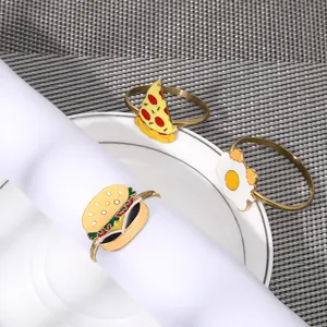 Detailed view of enamel food-shaped napkin rings including burger and pizza designs