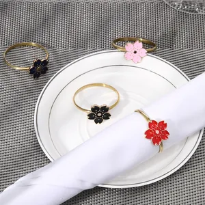 Golden cherry blossom napkin rings with colorful enamel petals for dining table decor