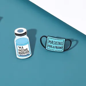 Creative enamel pin set featuring vaccine booster bottle and blue mask for medical theme