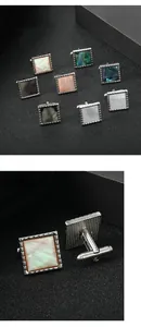 Macro shot of silver square cufflinks with iridescent shell inlay and textured borders