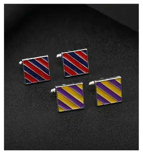 Close-up of square metal cufflinks with enamel twill pattern in red, blue and purple