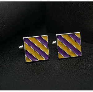 Macro detail of square cufflinks with purple and yellow stripes and bullet back closure