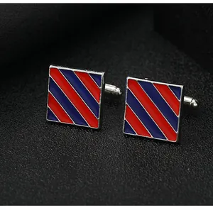 Close-up of square cufflinks with red and blue diagonal stripes on a silver metal base