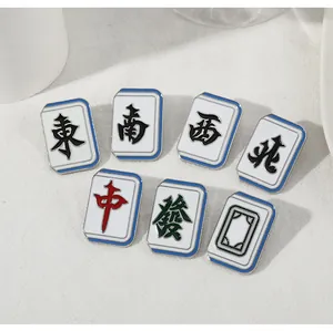 Detailed view of traditional Chinese Mahjong tile enamel pins featuring colorful characters