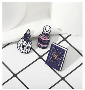 Gothic enamel pin set featuring a potion bottle, magic book and skull with purple candle