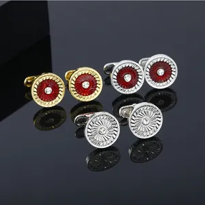 Three pairs of elegant crystal cufflinks featuring red enamel and silver spiral patterns
