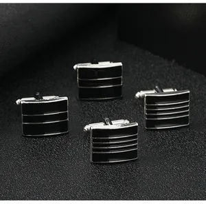 Close-up of black rectangular striped cufflinks with classic silver metal T-bar toggles