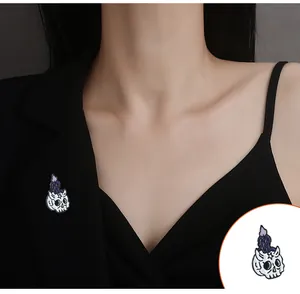Gothic skull and melting purple candle enamel pin badge styled on a black blazer lapel