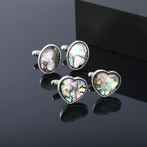 Elegant silver square cufflinks with natural colorful abalone shell inlays on black reflective surface