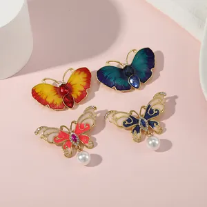 Broches papillon élégantes avec émail multicolore, strass et pendentifs en perles