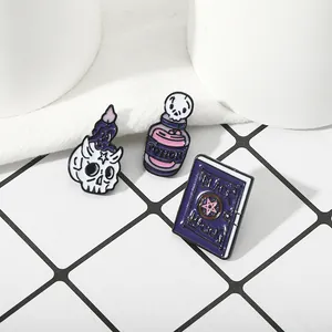 Three-piece Halloween enamel pin set with skull candle, potion, and black magic book
