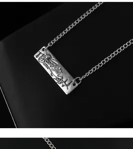 Close-up of silver mountain and sun relief pendant with intricate engraved details