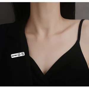 Close-up of Maybe=Yes/No+No/Yes enamel pin displayed on a black blazer lapel