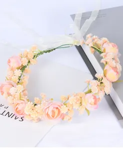 Detail of pink floral crown with roses, green leaves and adjustable white organza ribbon